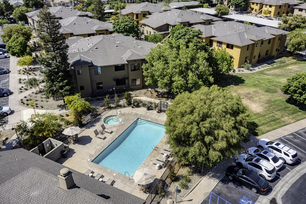 an aerial view of an apartment complex with a swimming pool and parking lot  at Polo Villas, California, 93312
